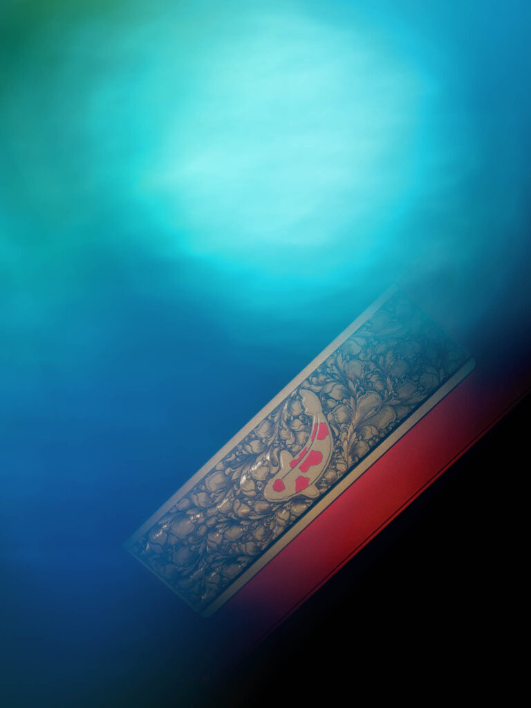 Red-framed keyboard case with an ornate silver floral keycap design against a blue and teal gradient background